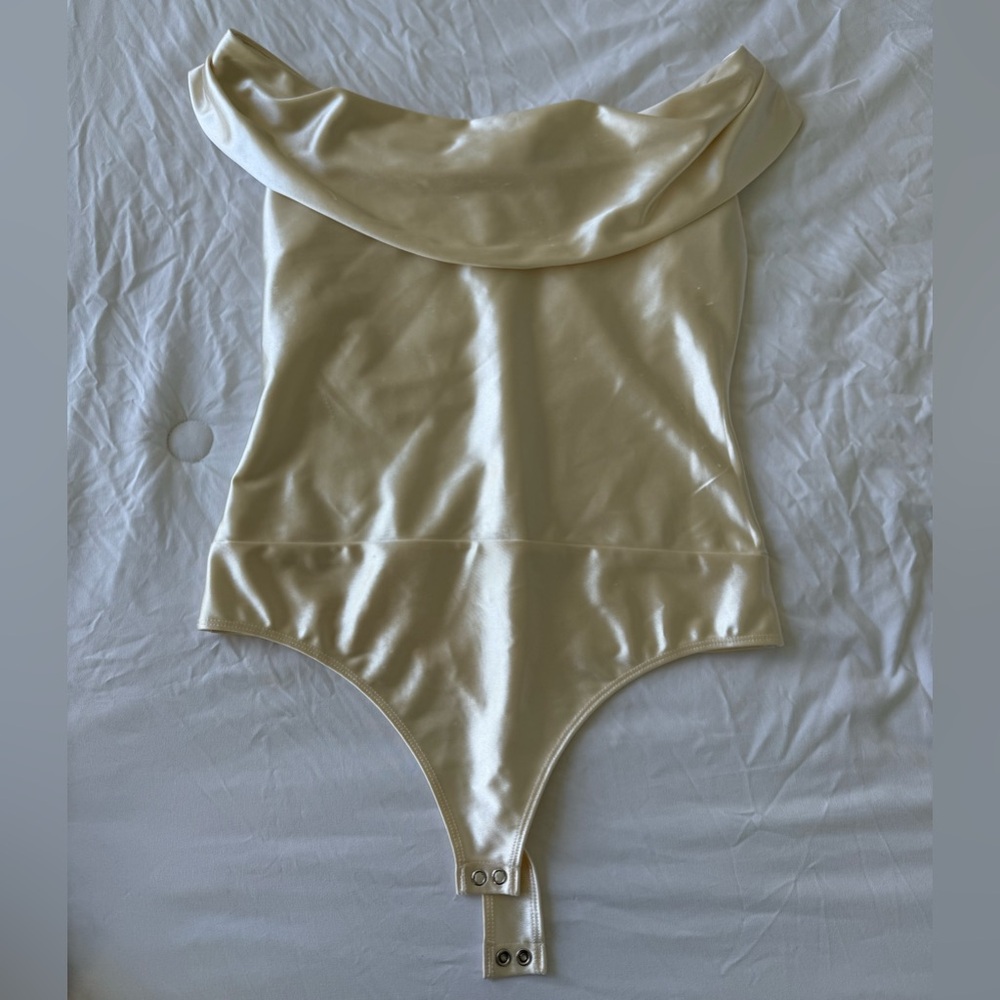 Express off the shoulder bodysuit in champagne color. Small